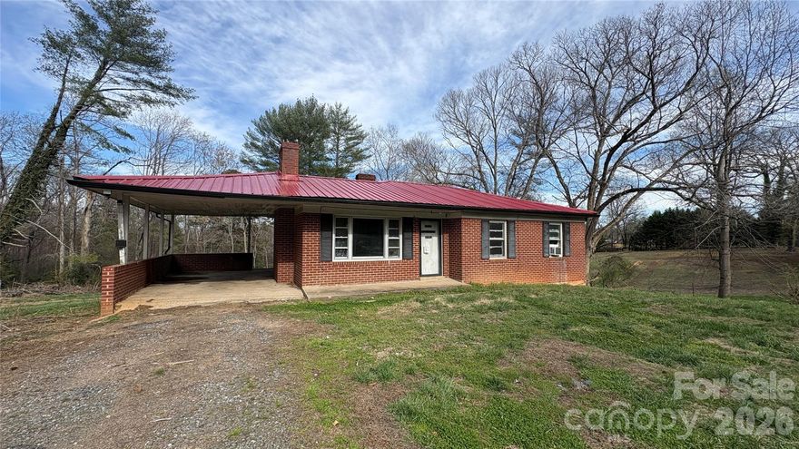 Excellent investment opportunity on this 2BR/1BA brick ranch with full unfinished basement in Morganton, NC! Located on almost 1 acre lot, this house has a single carport attached. Construction appears to have begun in one of the bedrooms to incorporate extra space for a sitting area/den and closet. Kitchen/Dining area also has laundry connections. Spiral staircase leads from the living room to the basement. There is also an exterior entry door into the basement. City of Morganton provides water; Unknown sewer - Burke County says it should be a septic tank but they were unable to locate a permit. Sold As Is/Where Is.