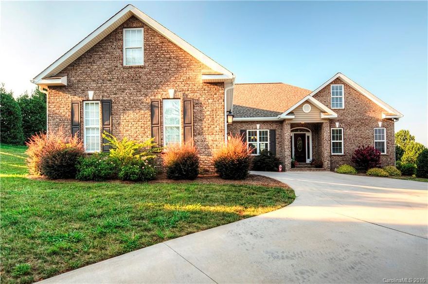 Must see 4 year old custom full brick home in upscale neighborhood with curbs and streetlights.  Split floor plan with Master and two guest rooms on main floor.  Owner completed fully finished living quarters upstairs with private entrance that includes mini-kitchen and full bath, perfect for guest suite, in-law suite or family rec area.  Enjoy quiet evenings on covered porch overlooking private backyard. Enjoy instant hot water with the tankless water heater. 2 car garage with storage room.