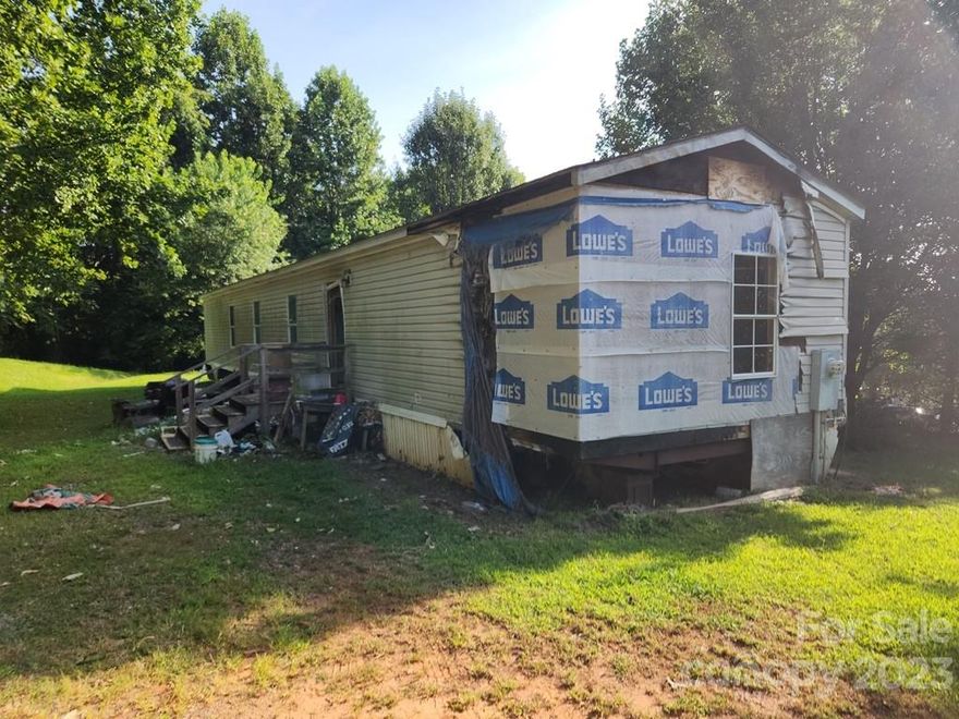 0.74ac level lot tucked away in a manufactured home community just 15 minutes to downtown Marion. Singlewide mobile home currently on the lot requires extensive renovations. There appears to be a well on the lot, but the well pump appears to be missing and it is currently unknown whether a septic system is installed. It is the buyer's responsibility to further investigate if of concern. The seller cannot likely convey a mobile home title, so it will likely  be treated as personal property. Unknown what year the mobile home was constructed (unable to locate the data plate). Likely a 90's model, but input 1980 to err on the side of caution. Sold as-is. Seller/Listing Agency make no representations.