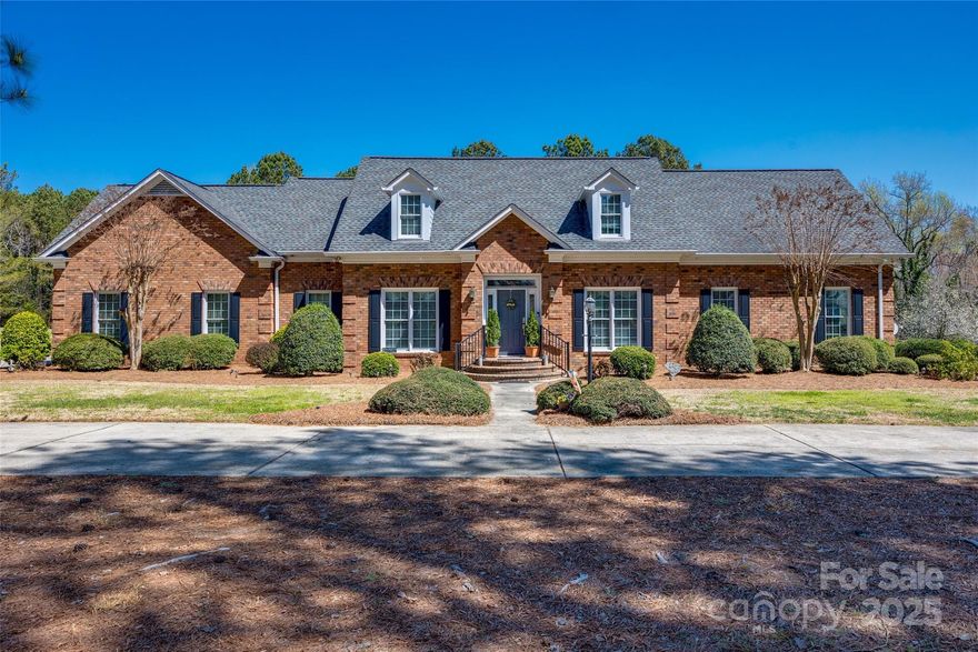 Quietly nestled in a wonderful location in Clover near Clover schools, this beautiful large, all brick home with 4 bedrooms and 3-1/2 baths is ready for its new owner.  This home sits on 5 partially wooded acres.  The front yard is graced with a circular driveway, overlooking a large pond across the street.  Inside, you will find an open kitchen and sunroom with tall ceilings, detailed moldings and a classic feel. The built-in bookcases and gas fireplace beckon you to sit down in the living room.  At the front of the house, you have a large dining room and a study/music room or office. The primary bedroom and bathroom are on the main floor.  Upstairs, there are 2 bedrooms, 2 full baths, and a bonus room. A special feature of the house is walk-in attic space galore! Some of it might even be finished by the new owner for extra living areas if desired. This well-built home in this location is a rare find in York County.  We can't wait for you to see it!