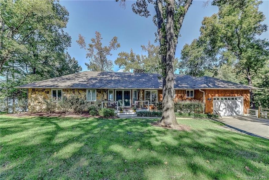 Stunning main channel Lk Wylie waterfront home w/panoramic views & deck access from most rms.. GR  w/soaring stone FP & vaulted ceiling. Frml dining, eat in kit w/ granite, tile, island & lots of cabinets. Main Master and Guest, both w/ commanding views. Lower level has 2nd Gr room w/ FP, lg entertaining bar, 3 bdrms, 2 flex rms, and storage rm. Dual decks across back of house open onto breathtaking views. Gentle slope to beach. Lg dock w/ covered slip.  Irrigation from lake.  2 lots total .71ac