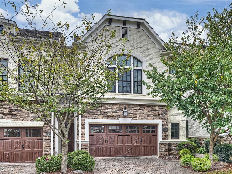 This townhome is outstanding! It is classically beautiful with a modern, updated, light and airy design. It features 10 ft. ceilings, coffered and tray, custom moldings, light hardwood floors throughout, and the windows are exceptional. The windows across the back and side of the second floor living and dining room offer gorgeous views of the outside and bring in great light. The design of the staircase is stunning and is a highlight of this home. The kitchen offers high-end Thermador appliances, light custom cabinetry with under-counter lighting, light granite, a large island for gathering, plenty of storage, and a walk-in pantry. The primary bedroom suite has a gorgeous window, a spacious bathroom with an oversized shower, and a walk-in closet with custom closet design. This home also offers a main floor suite with private bathroom and a third floor suite with private bathroom. There is an additional first floor office or second living room. This home also has a pretty paver patio (which may be fenced with ARC approval)and a second floor balcony, perfect for relaxing while enjoying the private back yard. Two powder bathrooms, a full-sized laundry room, a drop-zone, a walk-in attic, and a 2-car garage are additional special features of this home. Good guest parking available. On top of all this-you are right beside South Park Mall, Phillips Place, and all the great restaurants and shopping nearby!