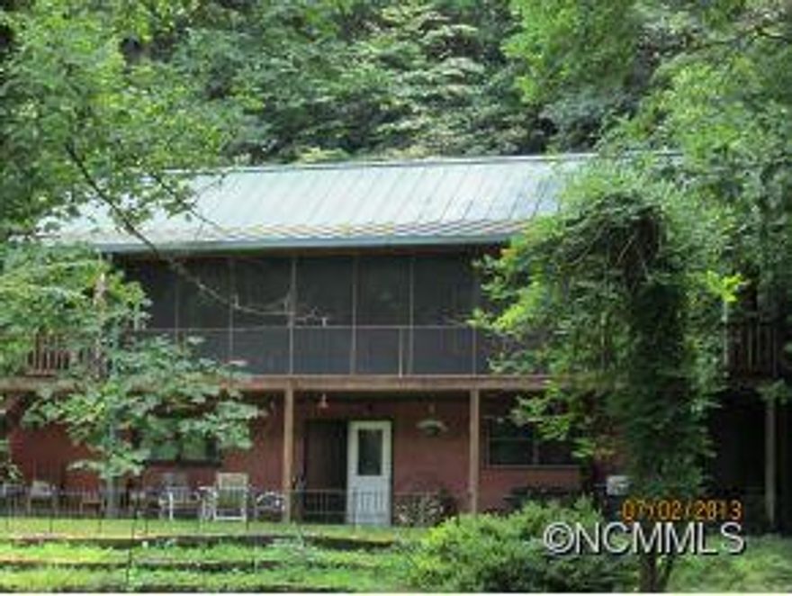 Awesome log cabin nestled in the rhododendrons, with nice rolling creek, level garden area, 2 out buildings, 2 fenced in areas for dogs and a chicken coop. Lots of bamboo and a picnic area.  What more could you ask for country living?  Only 4 miles from I-40 and 15 minutes to Blk. Mtn. and 10 minutes to Marion. This is a must see for anyone wanting a log home with land and a steam. Additional building lot with septic and well in place.