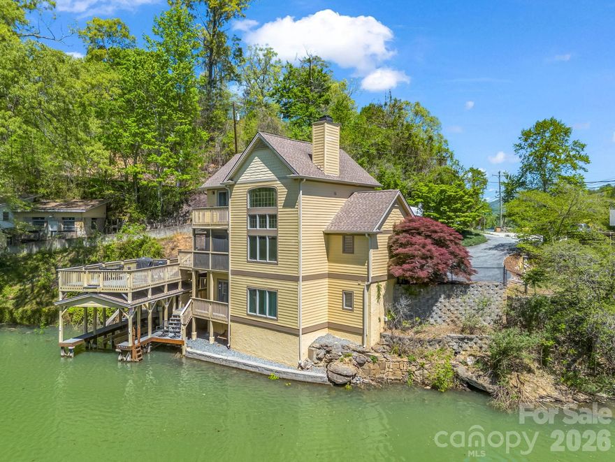 Experience the beauty and tranquility of true lakefront living on stunning Lake Lure. Ideally situated on desirable Tryon Bay Circle, this 3-bedroom, 2.5-bath home offers a rare opportunity to enjoy direct waterfront access complete with a private boathouse—perfect for boating, kayaking, or simply soaking in the peaceful lake views. Thoughtfully designed for comfort and relaxation, the home provides inviting living spaces and the ideal setting for both everyday living and memorable gatherings with family and friends. Brand new HVAC and new carpeting on the upper and lower levels, both installed in 2025, add comfort and peace of mind. Spend mornings on the water and evenings taking in the serene surroundings that make Lake Lure so special. Conveniently located just minutes from Chimney Rock Village, Chimney Rock State Park, and the area's charming shops, restaurants, and outdoor adventures. Whether you're searching for a full-time residence or a refined lake retreat, this exceptional property captures the essence of the Lake Lure lifestyle.
