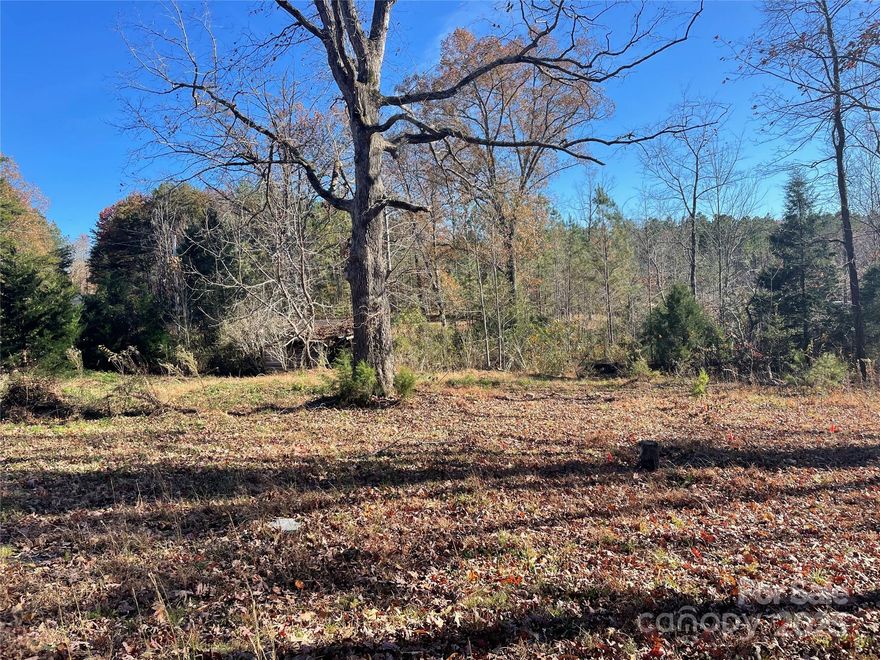 This .97 acre cleared lot is located in a remote section in northern Rutherford County. There is an old dilapidated wooden structure on the east side of the property that need to be torn down. Also, there was previously a mobile home just above the old wooden structure that has been removed from the property. The septic records have been applied for, but there is a septic system of some type that previously serviced the mobile home that was there. The well to that house was on an adjacent property and is no longer in use, so a new well would be needed. There are no known restrictions on this property, so you could do whatever you like with it. There are some nice close up mountains views from this property.