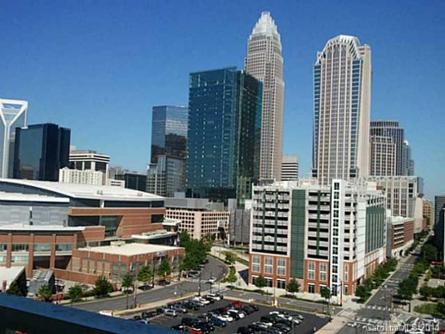 Welcome to the City!   Fantastic panoramic views from this condo overlooking the city and the basketball arena. 
Enjoy a glass of wine on your balcony while watching the sun set behind Charlotte's skyline.   Modern loft unit has bamboo floors and granite countertops.  Large Master and closet with laundry.  Tons of storage.  Gated parking garage with dedicated space and secure entry  building give you peace of mind.  terrace with grill is open to all residents.