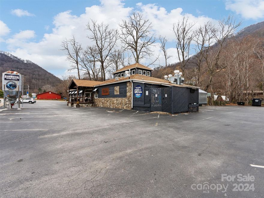 Incredible commercial opportunity with strong financial performance in the heart of Maggie Valley! With its prime location near the entrance of Catloochee Ski Lodge and the serene setting beside a river with stunning mountain views for attraction for both locals and tourists alike.The combination of an upscale dining experience  is a unique offering that could cater to a wide range of customers. The ample seating for 122+ guests plus full bar area, along with outdoor seating and entertainment areas, ensures that there's plenty of space for patrons to enjoy themselves.Having a state-of-the-art kitchen with brick pizza oven is essential for delivering high-quality food and drinks consistently, this establishment is set apart from others in the area. With most all these features and amenities updated, this space has become a go-to destination in Maggie Valley, drawing in visitors year-round. It is an excellent opportunity for someone with a passion for hospitality and a vision for profits. This is one of three locations we have in Haywood county, the other two are 1940 S Main St Waynesville and the other is 339 Park Street in Canton.