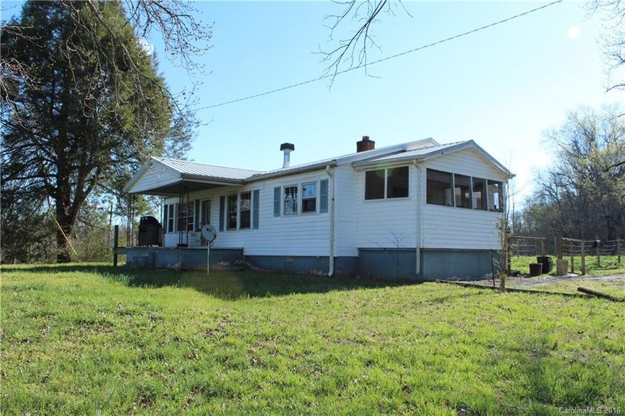 This is a very attractive property. It is almost 3 acres and is only a few miles from the equestrian center. The house has vinyl siding and a metal roof. The hardwood floors need refinishing but could be beautiful. A little TLC goes a long way and this could be a beautiful property.