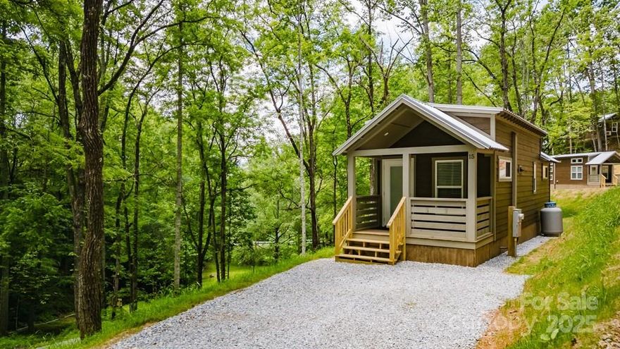 PRICED REDUCED! Discover is cover the ideal combination of contemporary tiny living and tranquil mountain ambiance in this brand-new 1-bedroom, 1-bathroom tiny home. Home features a full kitchen with gas range and small dishwasher. Stackable washer and dryer. A perfect nook with bunk beds in the hallway across from the full bath with stand up shower. The bedroom is featured in the back of the tiny home with a built in closet space. This tiny home would also make a great vacation rental.