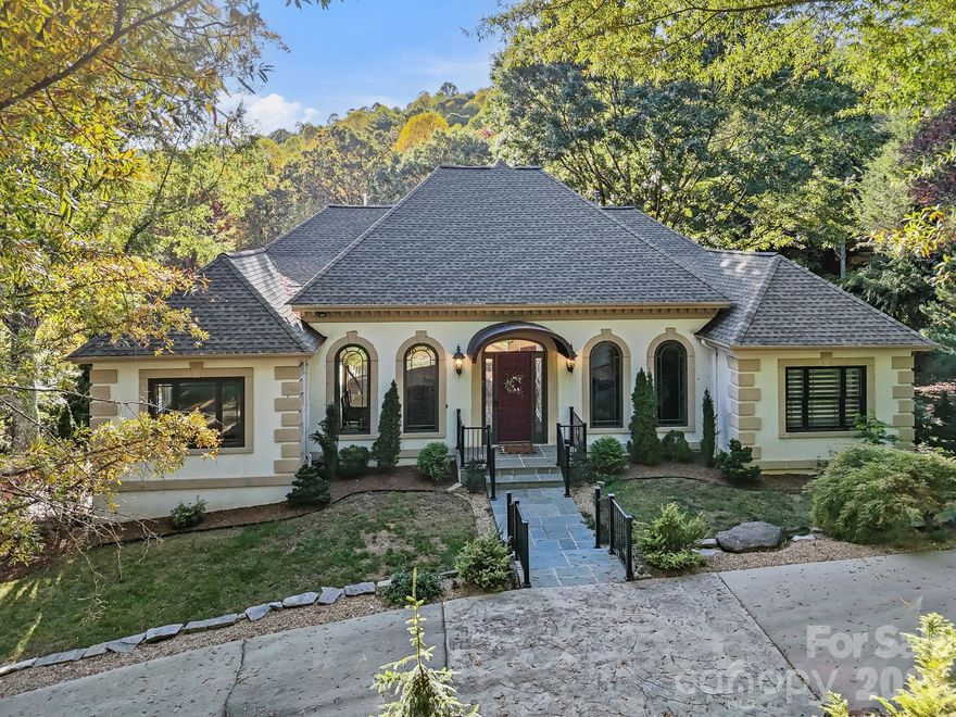 Welcome to 31 South Ridge Road in Wilson Farm. This home simply couldn’t be built today. The property is a rare fusion of timeless craftsmanship and natural artistry, set on 2.68 acres of manicured grounds worthy of an arboretum.

The landscape has been thoughtfully designed into a living showcase, featuring mature specimen plantings, winding walking paths, a tranquil pond, and award-winning trees that create an ever-changing display through the seasons. The pond serves as the centerpiece of the property, perfectly framed by views from the grand living room and surrounding gardens. From nearly every window, you’re greeted by views of your own private arboretum or distant mountain vistas beyond.

Inside, the craftsmanship is extraordinary. Tall ceilings and a grand living room finished in exquisite custom woodwork showcase the home’s architectural scale and warmth. Ornate, hand-crafted crown moldings reaching nearly two feet in height reflect a level of custom carpentry and artistry rarely seen today. Every finish, trim, and architectural detail was executed with precision and pride, resulting in a home that feels as much like a work of art as a residence elegant, warm, and entirely unique.

Thoughtfully sited for privacy within one of Hendersonville’s most desirable neighborhoods, this property offers a truly irreplaceable opportunity. It was built with a level of care, quality, and design that endures through generations.