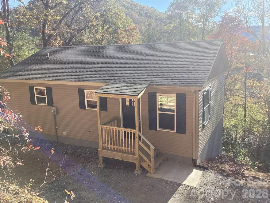 Brand new construction, near Smoky Mountain National Park and Cherokee. Septic system is for 3 bedroom so 3rd bedroom can be added on lower level. The house is at the end of a short, private road. Enjoy the quiet, private, beautiful mountain view. Open floor plan on main level with knotty pine ceilings, cabinets, doors, and trim. Floors are luxury vinyl plank throughout home. Main level has deck off living room area. The primary bedroom has an en-suite bath with tiled shower, double sink vanity, and huge closet. The kitchen has quartz counters and stainless-steel appliances. Lower level has open living area with separate space for office or third bedroom. Bedroom has wood ceiling, large closet, and bath with tub. Separate laundry room and utility room. Spacious decks off both levels. Separate Heat/ Ac unit for each level. Propane gas stove with logs. Quality stick-built home, low maintenance.