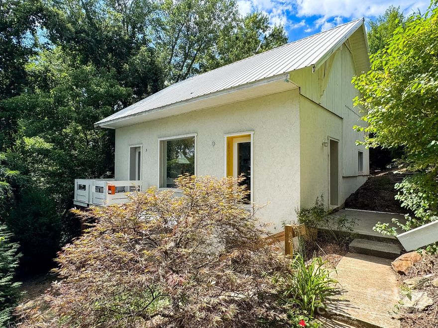 Welcome to this stunning 2-bedroom, 2-bathroom modern minimalist home in the sought-after Chicken Hill community of Asheville. Nestled in a tree-house-like setting, this artistically designed residence features 10' ceilings with an open kitchen and living area on the main floor, perfect for entertaining. The upscale ash wood cabinetry in the kitchen and bathrooms adds unique panache, complemented by many custom-designed cabinets and furnishings, which, along with the art, are negotiable. The lower level offers a full living area and an apartment, providing flexibility for guests or rental income. Located just a short walk from the vibrant River Arts District and downtown Asheville, this home combines style, function, and an unbeatable location. Don’t miss the chance to own this very unique property!