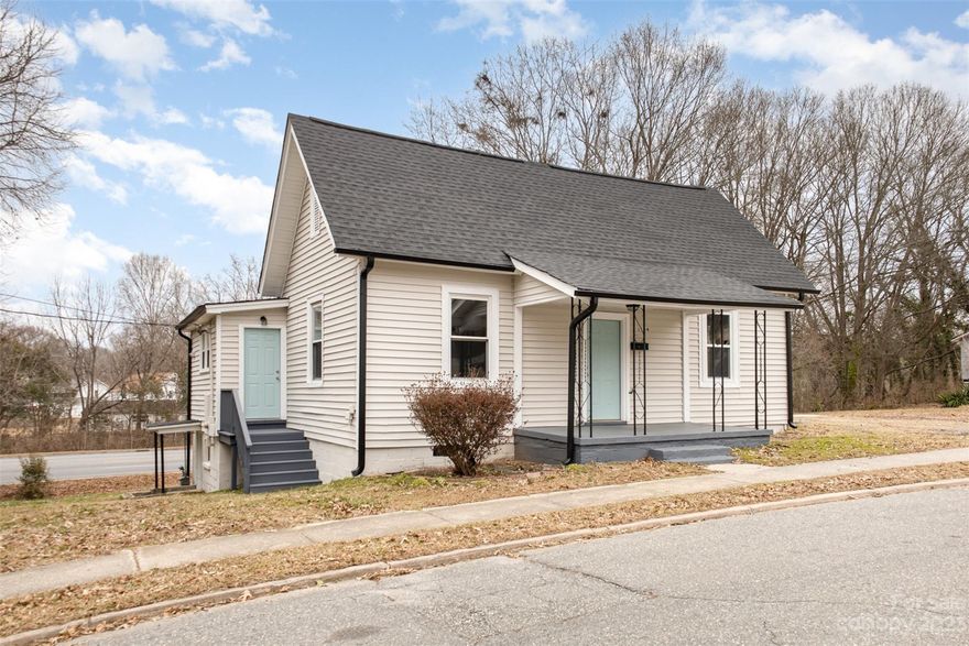 Incredibly renovated Gastonia bungalow offering you modern living + all the essentials, with a new roof, flooring, paint, appliances + more! The curb appeal is evident upon arrival, with a bold teal door and covered front porch, the perfect spot to enjoy your morning coffee. Once inside, you'll be blown away by the beautifully flowing + brand new LVP flooring throughout the home. With a fresh coat of paint + natural light pouring in, what's not to love? The spacious living room is open to your brand new kitchen, featuring SS appliances that convey with the home, gorgeous white cabinetry, bold granite counters + space for a dining room table. Both bathrooms have been updated for modern living + primary bedroom is a good size and the 2nd bedroom is adjacent to the laundry room and could also be a large office. With an unfinished basement, there are endless possibilities here if you need extra storage. This is the perfect starter home or investment property to add to your portfolio!