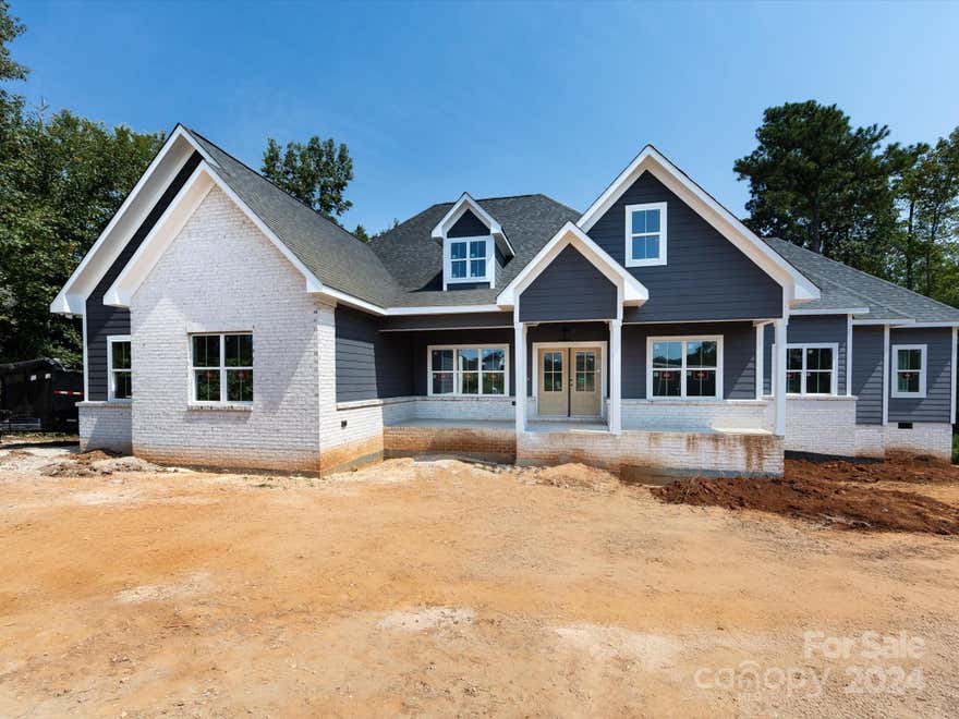 Gorgeous Custom New Construction home-Large, open floor plan with vaulted ceilings-Split bedroom plan with 4 full bedrooms & 3 baths-Over 500 sq ft of covered outdoor living space w/wood ceilings-Screened porch-Covered  rocking chair porch-Large living room w/ vaulted ceiling-6" wood floors-Kitchen has large working island & custom T-table- Quartz countertops, farm sink, backsplash, direct vent hood & high-end stainless appliances-Walk in pantry with wood shelving, cabinets & Quartz tops-Laundry with built in cabinets-Generous secondary bedrooms with walk in closets-Custom molding package with 6 panel doors-Secondary baths with dual basin vanities & tile tub surrounds-Primary suite with his/her walk in closets & "secret" closet with built in safe-Primary bath with dual basin, raised height vanity & stack cabinet, walk in shower & WC-Huge back, screen porch overlooks your 1+ acre lot-Home backs to natural wooded area for amazing privacy-Too much to list! Call anytime for private showing