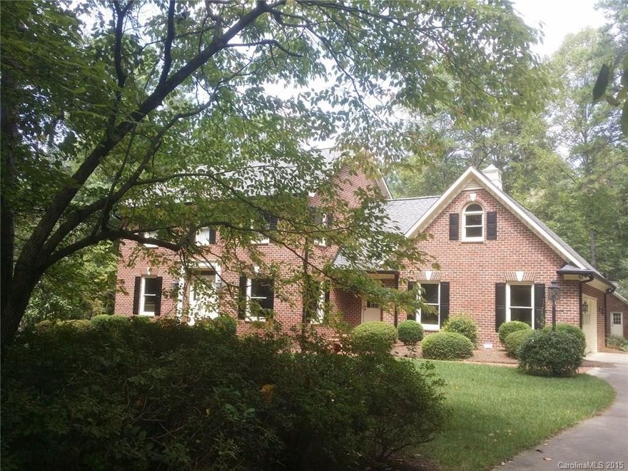 Custom brick home on 1.5 acre lot in NW Cabarrus. Features on main level include formal areas/flex space; fully equipped kitchen with breakfast bay overlooking private sanctuary; large family room with fireplace opening to heated and cooled sunroom. Upper level offers 3 bedrooms plus huge L-shaped bonus with separate entrance. 21x31 garage includes heated and cooled workshop. Expansive terrace for entertaining plus large brick outbuilding.  Convenient to interstate yet utterly secluded.