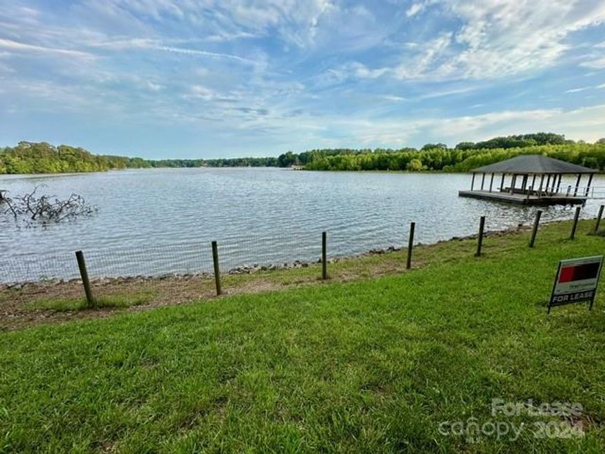 Lakefront living in Belmont!! 3 bedroom 2 full bath home. Beautiful Views from upper and lower levels! Two decks, a screened side porch, and a large 1.04-acre waterfront backyard with a private pier and floating dock! The kitchen has updated stainless appliances, Corian counters, and subway tile. Two bedrooms are on the upper level with a full hall bath featuring a tiled step-in shower. The family room has a wood-burning fireplace with views of the lake. The lower level has a nice-sized den with water views, a bedroom without a closet, a full bathroom with tub/shower, and a dry kitchenette room with cabinets and a full-sized refrigerator with an eating area. Lawn care included. Dock should hold a pontoon and or jet skis. Pets conditional. **No Cats**.