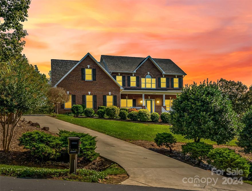 Nestled in desirable Deerfield in Mountain View, this beautiful 4BR/3.5BA home features a wrap-around front porch, large in-ground pool, two car garage, & a full basement! Incredible kitchen with granite countertops, ample storage space, kitchen island, & breakfast nook area. Two living areas, one w/ a fireplace & second w/ natural light from the front porch. Large dining room perfect for gatherings! Office, laundry, & half bathroom on main. Spacious primary bedroom with double closets along with a small gym room. Primary bathroom w/ a beautiful walk-in tile shower, large jetted tub, & double sinks. Large basement w/ storage space & full bath. Pool area w/ grilling space & stunning landscaping throughout. Located in the Mountain View Elementary School, Jacobs Fork Middle School, & Fred T. Foard High School district! Great location close to HWY 127, shopping centers, Hickory, Bakers Mountain Park & Newton! Call to schedule your private tour today!