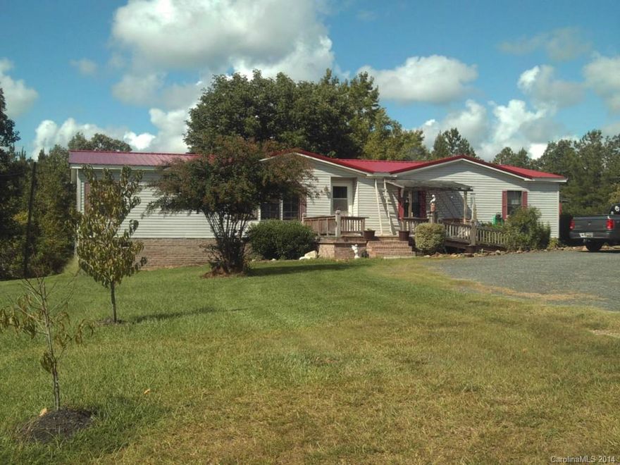 REDUCED!  Don't miss this spacious and welcoming home, located close to the NC/SC state line, situated on over 4 acres.  It features an open/split floor plan with 3 bedrooms and 2 baths.  The living room has a corner fireplace with custom shelving that is adjacent to the large kitchen/dining area.  Enjoy the wildlife that are attracted to the back yard and private pond from the screened porch/deck or fish from your own floating dock. There is plenty of storage for your hobbies and room to roam.