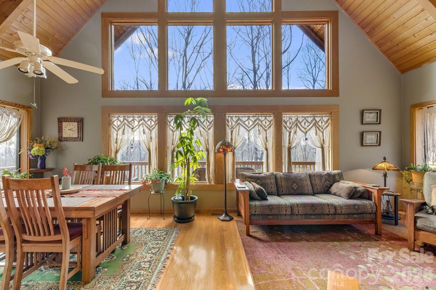 Tucked away at the end of the road, this quality-built cabin offers exceptional privacy, sweeping mountain views, and a light-filled open floor plan. The great room features dramatic floor-to-ceiling windows that bring the outdoors in and create a warm, inviting gathering space.

The home offers three bedrooms and three full baths, with two bedrooms conveniently located on the main level and a private upper-level bedroom retreat. The lower level includes a spacious family room with outdoor access, a full bath, and a versatile flex space ideal for a home office, gym, studio, or creative pursuits. In addition, there is a one car garage used as a workshop. Ample decks and porches expand your outdoor living.
If you would like to stay connected, Fiber internet is available

Adding to the sense of tranquility, nearly 700 acres of nearby land is preserved and protected by the Southern Appalachian Highlands Conservancy, ensuring long-term natural beauty and serenity just beyond your doorstep.