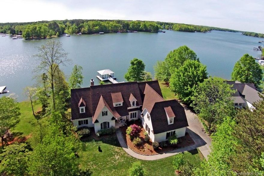 Captivating Estate! Newer Lake Home offers Big Waterfront Views from nearly All Rooms! Privately situated Lot.  NO HOA, Low Iredell Taxes. 4 Car Garage ! Two Covered Boat Slips w/ Lifts! Open and inviting Two story Great room with Post and Beam accents; Stone Fireplace. Real Hardwoods throughout. Solid Wood Doors. Well appointed Kitchen with Granite counters and Custom Cabinetry. Master and 2nd Bedroom suite on Main level. Walk In Closets. Spa Bath suite. Huge Vaulted Sun Room with Water Views!