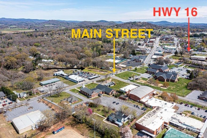 DOWNTOWN TAYLORSVILLE NC on Main Street!! MULTI USE Zoning TOWNHOMES/ DUPLEX RENTALS or COMMERCIAL possibilities (BUYERS must verify plans with zoning to be sure). GREAT location for RENTALS of residential/commercial. MULTI USE gives you more options on zoning. This .59 ACRE~ corner lot presents a unique opportunity for potential buyers with its MU zoning designation, water and sewer meters on the property, and proximity to various amenities in downtown. The .59-acre lot, which is mostly level and cleared, offers commercial potential in the front area while allowing for additional possibilities like duplex/townhomes in the back. The current owners plans IF approved by Zoning was to construct a small office in the front and duplex / or a couple cottages in the back for rentals! This was not formally approved however discussions with the zoning dept. seemed favorable. Recent improvements made by the current owners, are: demolition of the old home, grading, tree removal and clearing!! BUYERS please call Alex. Co. Zoning 828-632-1000 to discuss any questions on what you plan to do with the property.