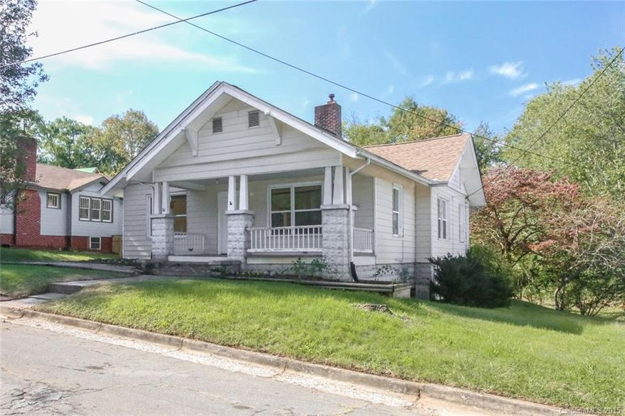 Arts and Crafts 1920's Bungalow within walking distance to the shops, restaurants and breweries in West Asheville, River Arts District & Downtown. This house has great character and an unbelievable large and "flat" lot. Renovations include newer roof, windows and an updated kitchen. Move in ready (bath could use remodel) but also could be renovated to include a master suite plus sitting room in the attic. Section of the bead board ceiling in the attic is removed to show the true ceiling height.
