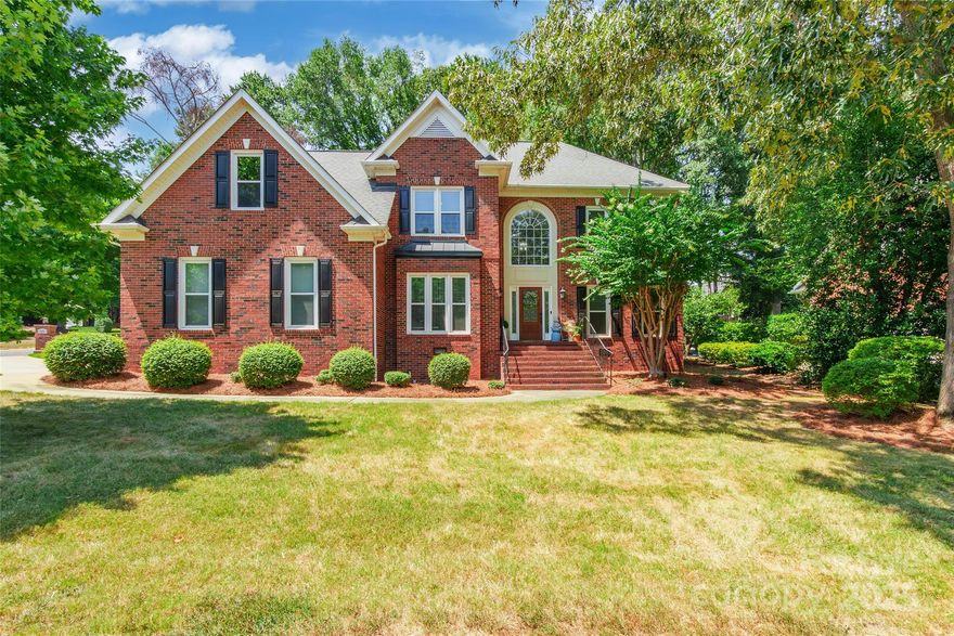 Custom stately full brick home in popular Bailiwyck in Fort Mill, SC! This fabulous home features neutral paint, formal living room w/crown molding and bar, formal dining w/crown molding, upgraded light fixtures, chair rail w/wainscot below, family room with gas log fireplace, kitchen has ceramic tile, granite countertops, tile backsplash, and stainless appliances. BR on main level connected to full bathroom. Primary suite has tray ceiling, LVP flooring, crown molding, & ensuite with garden tub & separate walk-in shower, dual vanities, & walk-in closet with custom built-ins. All secondary bedrooms are neutral with LVP flooring. Large bonus room. Amazing extended custom pavered back patio w/ fire pit, gas grill & smoker, and custom lighting surround the patio. Finished garage with epoxy flooring, shelving, and high lift garage door. Fully encapsulated crawl space w/sump pump, 2 Nest thermostats, and huge walk-in attic storage. Very short distance to club house, pool, and tennis courts!