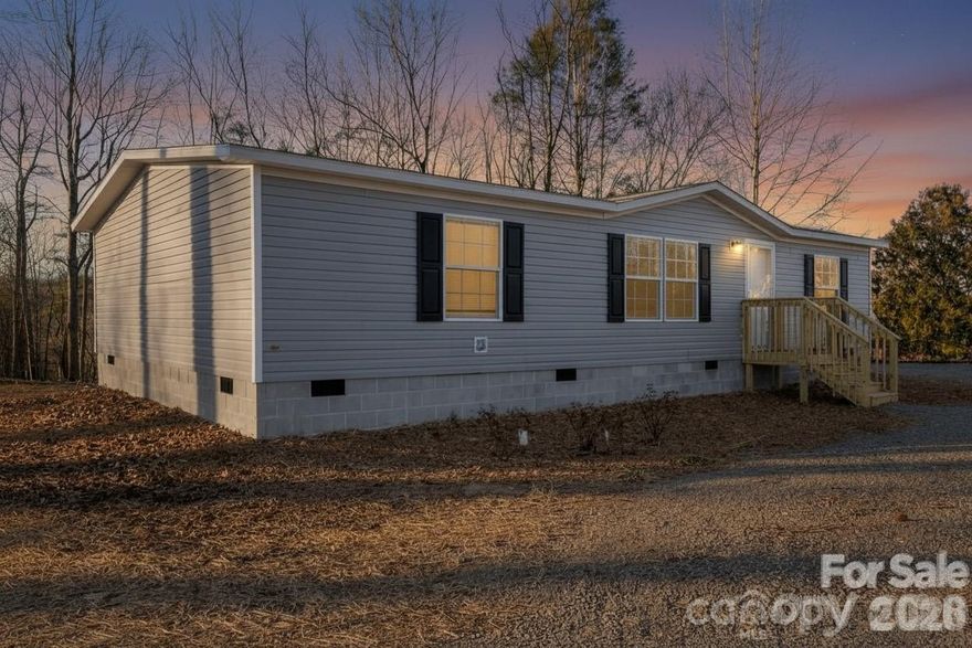 Buyer financing fell through. Back on the market! This new home offers modern design, functional space, and comfortable living in a convenient location close to shopping, dining, and everyday amenities. Featuring 3 bedrooms and 2 full baths, this home showcases an open and inviting layout designed for today’s lifestyle. The spacious kitchen flows seamlessly into the living and dining areas, making it ideal for both everyday living and entertaining. The primary suite includes a private bath and generous closet space, providing a relaxing retreat at the end of the day. Situated on nearly half an acre, the property offers room to enjoy the outdoors, with a large rear deck perfect for grilling, relaxing, or hosting gatherings. An added bonus is the on-site camper hookup with electric plug-in, water, and septic connection—ideal for guests, travel enthusiasts, or additional flexibility. New 10 x 12 outbuilding with loft and electircal. This home delivers space, comfort, and value.