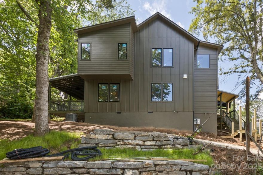 Fabulous 2023 modern 4-bed 3 bath Green Built home in the heart of West Asheville! Walk to River Arts District, award-winning restaurants & breweries and come home to a friendly neighborhood on a quiet road. Step inside to a flowing open floor plan and a stunning kitchen with beautiful quartz countertops and luxury Z-Line black stainless appliances. Step out onto a private deck with a view overlooking a wooded back yard. Spacious primary bedroom suite is on the upper level with tiled walk-in shower with soaking tub and roomy walk-in closet with built-in shelving. Beautiful hardwood floors throughout the main and upper levels! The second story offers 2 more bedrooms connected by a Jack & Jill full bathroom and a family room. Light filled open floor plan with tons of windows, 9' ceilings on the main level and vaulted ceilings upstairs. Features 2 car off street parking. Another great property built by Kiril Nikolov and Multi-Construction.