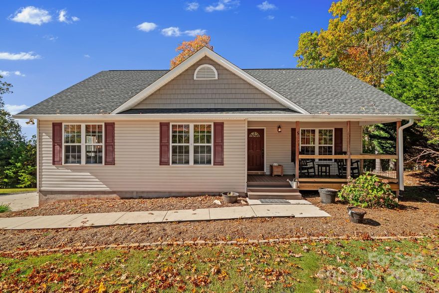 Welcome to 5 Damascus Road, a beautifully maintained one-owner mountain home with breathtaking views on a nearly half-acre lot in Alexander. Recent improvements include a new roof in 2023 with 30-year architectural shingles, new Andersen sliding doors upstairs and downstairs that bring in abundant natural light and showcase the views, fresh interior paint, new composite deck boards on both the front and back, and a poured concrete driveway in 2021.

This 3-bedroom, 3-bath home offers a light-filled, open layout with vaulted ceilings, a stone fireplace that adds warmth and charm to the living room, and a combination of hardwood and LVP flooring throughout with no carpet. The kitchen features rich cabinetry, modern appliances, and generous counter space, ideal for everyday living and entertaining.

The lower level expands your living space with a large family or recreation room, full bath, and walk-out access to the backyard. This versatile area works perfectly as a movie room, teen hangout, or hobby space.
The setting is truly special with sweeping mountain views from the covered front porch, sunny back deck, and even the primary suite window. A spacious two-car garage provides excellent storage and functionality.

Conveniently located approximately 10 minutes to downtown Weaverville, 15 minutes to downtown Asheville, and just 5 miles from the new AdventHealth hospital coming soon, this quiet neighborhood home delivers the perfect blend of comfort, quality upgrades, and an excellent location. Move-in ready and lovingly cared for by its original owner, don't miss this opportunity!