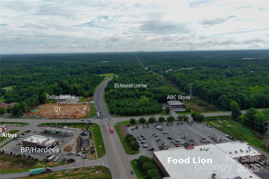 Prime Development Opportunity on Alexander Love Highway. Welcome to a remarkable investment prospect at 855 Alexander Love Highway in York, SC. Spanning an expansive 10.54 acres, this property is a canvas for visionary commercial or industrial development. Zoned for both Highway Commercial (HC) and General Industrial (GI) uses, it’s ideally suited to meet the needs of service oriented businesses, logistics hubs, or travel-centric enterprises.

Key Highlights:

Strategic Location: Positioned directly on a major highway, this parcel offers excellent visibility and accessibility for commercial traffic. The newly established QT (QuikTrip) across the intersection further underscores the area’s growing commercial appeal and consumer traffic. 

Flexible Zoning: With dual zoning designations, the site is well-suited for a range of development possibilities, from retail and dining establishments to warehousing and light manufacturing.

Growth Potential: The presence of a major convenience and fuel operator nearby signals a rising demand and a favorable environment for complementary businesses to thrive.

Seize the chance to develop in one of York County’s most promising commercial corridors. Whether you envision a service hub catering to travelers or a dynamic industrial space, 855 Alexander Love Highway is your gateway to growth. There may be an opportunity for mixed use rezoning adding a residential component to the back, full rezoning process would be needed for residential consideration. Frontage to remain hwy commercial or General Industrial.  Water and sewer available.

All information to be verified during due diligence:
York New roof tops:
This city has approved a total of 2,950 units, with 30% +/- completed, with
about 2,000 remaining to be completed at this time.
Property directly across the street has been approved for 66 townhomes
and 2 commercial outparcels