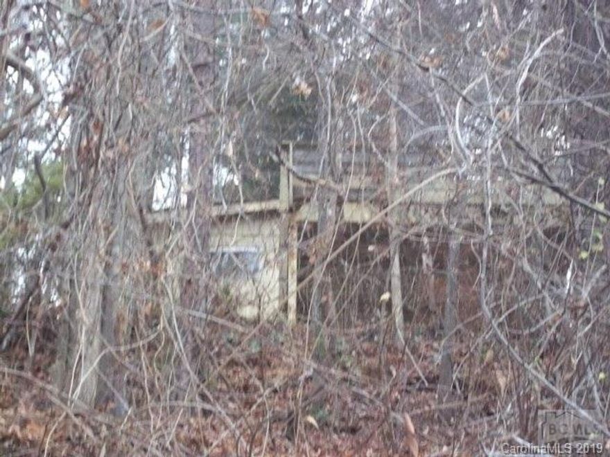 Being sold for land value only.  Small frame fishing cabin on this .47 acre lot within walking distance to Lake Hickory. All information per tax card. Buyer's agent to verify all data.