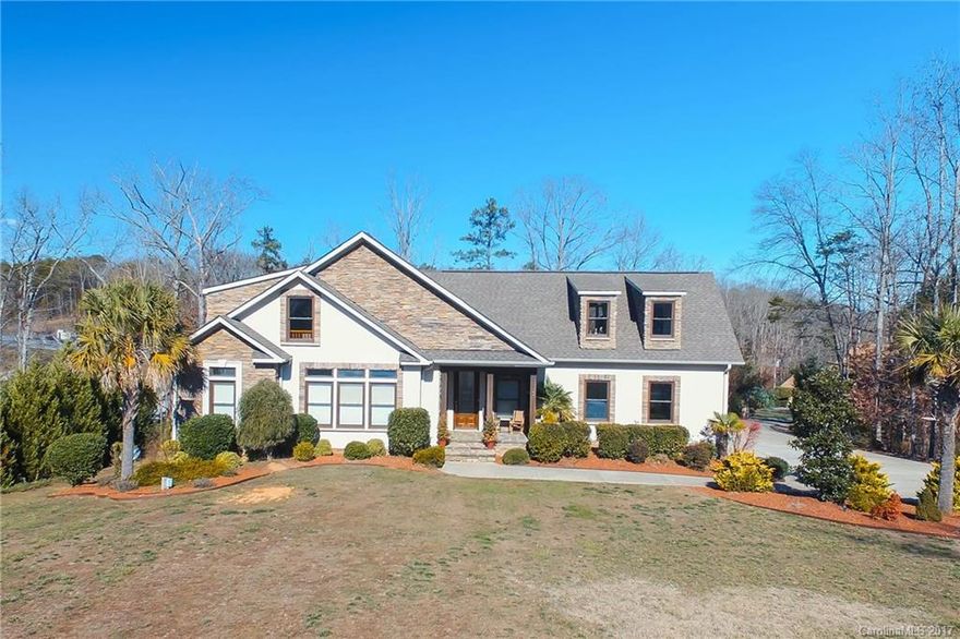 Gorgeous custom built waterfront home on a quiet cove with 1.46 acres! Open floor plan and move in ready.  Spacious master on main level w/sitting room or office,  Kitchen with stainless appliances, granite countertops open to great room and lake views.  2nd floor has 2 Bedrooms, 2 baths & bonus room.  Finished lower level w/rec room, media room, guest suite w/bath and heated workshop.This home has it all, plenty of outdoor living space great for lakeside entertaining, floating dock w/boat lift!