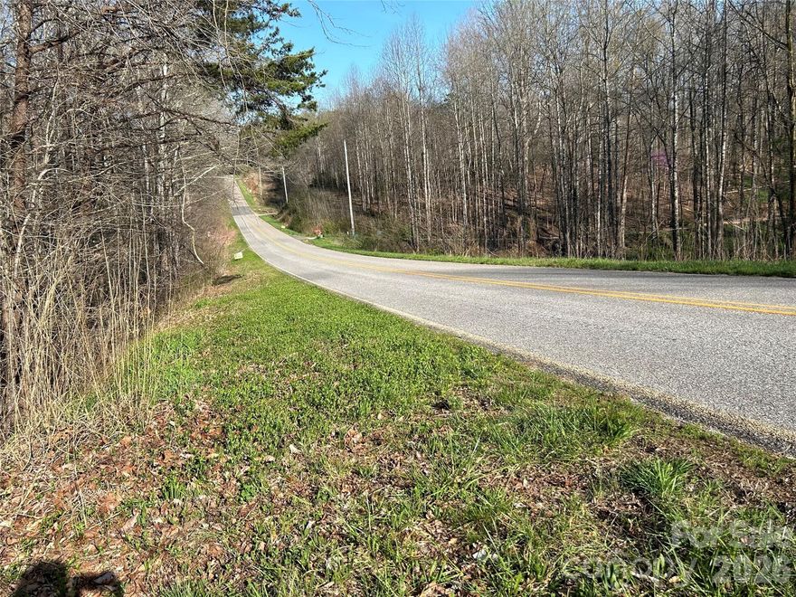 This pristine 6.62-acre tract in Northern Iredell County sits on the edge of the Brushy Mountains and offers the feeling of high-elevation seclusion while remaining incredibly convenient to major highways and metro areas.
The property features approximately 480 feet of road frontage, mature hardwoods, natural topography, and peaceful creek access. With multiple potential homesites, you can choose a private, tucked-away build or take advantage of the gentle terrain for a more accessible homesite. A recent survey is on file for added confidence and clarity.
There are no known restrictions and no HOA, offering flexibility for a primary residence, mountain retreat, recreational use, or potential development (subject to county approval). Property is in a farmland preservation district.  The surrounding rural character is thoughtfully maintained, helping protect the open, scenic setting.
Enjoy privacy and the beauty of mountain surroundings while staying just:
 • 10 minutes to I-77
 • Approximately 45 minutes to Boone
 • Around 50 minutes to Charlotte
 • About 40 minutes to Winston-Salem.
Properties offering acreage, water features, road frontage, privacy, and proximity to major cities are increasingly difficult to find. Whether you’re looking to build now or invest for the future, this tract offers a rare combination of natural beauty, flexibility, and location.
Buyer to verify utilities, septic, well, zoning, and intended use.