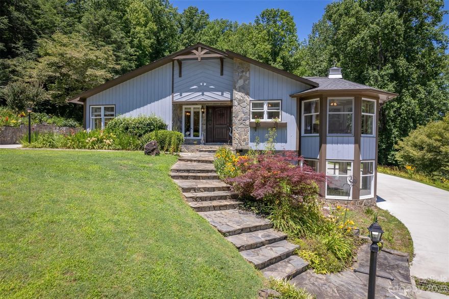 Stunning contemporary home on a quiet 3.65-acre lot with a pond and frontage on Wolfe Creek. The home offers 4,911 square feet of stylish living space, including two separate quarters. It is perfect for a multigenerational family or anyone who wants the flexibility of having a separate guest area or rental potential. The main level features a great room with vaulted ceilings and a double-sided gas-log fireplace between the living and dining area. The well-appointed kitchen is open to the great room and the breakfast area. The main level also has 2 bedrooms and 2.5 baths, including a spacious primary bedroom with two walk-in closets and an ensuite bath with a shower and soaking tub. Downstairs is the second living quarters, which has 2 bedrooms and 2 baths, plus a covered patio. The home is energy-efficient, with solar panels and a generator. This truly unique and special home is perfect for anyone who wants a beautiful, spacious, and energy-efficient home in a quiet setting.