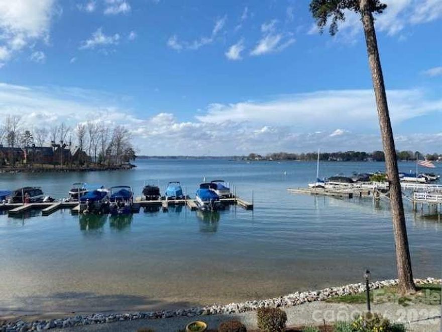 Magnificent waterfront, end unit townhome has a stunning open lake view with  assigned boat slip, private docks, and beach in popular area zip code. Beautifully updated interior, kitchen, and baths. Huge waterfront balcony and large lower level patio with over 600sf of covered outdoor living and endless sunrises and sunsets. 2 floors with ground floor beachfront walkout and beautiful landscaping and ample storage. Dedicated kayak/paddleboard storage near water and four large storage closets with over 230 sf non-hla.  Premier location with community pool, clubhouse and gardens, just minutes from I-77 on desirable Exit 28. Close to popular area amenities, greenway and walking distance to Jetton and Walter Henderson area parks.  Many rare and unique features, ready to move in. Furniture, boat and new hydro hoist lift negotiable.