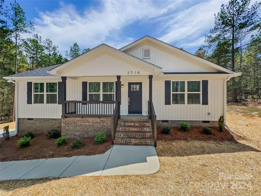 Brand New construction home on over an acre of wooded land in the Buford School District, just minutes from Waxhaw, NC too! This Beautiful home offers a great split bedroom floor plan with an Open Concept living area. As you enter from the welcoming Covered Front Porch you'll notice the lovely Laminate floors throughout and the vaulted ceilings in the living area. The kitchen offers bright White Soft Close Cabinets, Sparkling White Quartz counters, and Stainless Steel Appliances. Next to the kitchen is a designated Dining Area, Laundry Room, and access to the Large Rear Deck overlooking the wooded back yard. The Primary Suite has a spacious bedroom and Primary bathroom with Dual Vanity, Quartz Counters, Tiled Shower surround, and Large Walk-in Closet. The 2 secondary bedrooms are on the opposite side of the home and share a 2nd Full Bathroom that also has Quartz counters. The 1.24 acre wooded lot gives the home a nice private setting with plenty of trees.