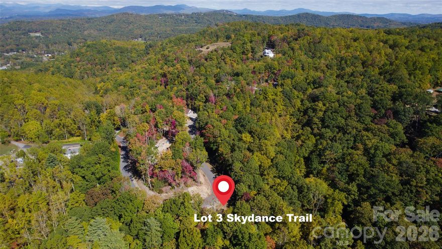 Welcome to 106 Skydance Trail, Lot 3 in the private mountaintop community of Skydance in Western North Carolina. Skydance is a special community offering the convenience, privacy, & natural beauty that the western North Carolina mountains are known for. It’s a private retreat without all the fuss of a country club community & only minutes from AVL airport, as well as the towns of Hendersonville & Brevard. Lot 3 is gently sloped & features beautiful hardwoods & other native flora. A seasonal spring-fed stream runs along one corner of the property, & there are 2 possible sites to choose from. One is near the road and is perfectly level, & the other is nestled in the woods. Electric is already at the site, the septic has been installed, the well permit obtained, and building plans are available. Skydance is close to Dupont State Forest, the Pisgah National Forest, & the Blue Ridge Parkway, as well as the Ecusta Trail, which is only about a mile down the road. Enjoy all that this beautiful area has to offer,  with a wide variety of outdoor recreational opportunities to choose from, including hiking, biking, fly fishing, waterfall exploring, rock climbing, and more.