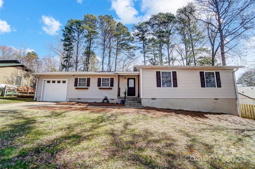 Welcome to this charming, ranch home in the Tega Cay peninsula! Enjoy the open floor plan, ideal for entertaining guests. Updated flooring in main living areas, complemented by soothing neutral paint throughout. The kitchen is pretty & functional w an oversized sink, convenient work island/breakfast bar, stainless steel appliances. Primary suite offers an updated bath, complete w a dual sink vanity, custom tile work, & a modern frameless shower. The hall bathroom is updated w custom tile work, stylish cabinetry, & fixtures.Convenience is key w the large laundry room. Outside, you'll find a rare gem - a large, flat yard, fully fenced for privacy, trees providing ample shade and plenty of space for outdoor activities and play. Home also offers a one car garage, a huge plus! Tega Cay lifestyle, offering access to a nearby lake, parks, pickle ball court, walking trails, golf course, & much more. Fort Mill School District. Don't miss out on the opportunity to call this wonderful home yours!