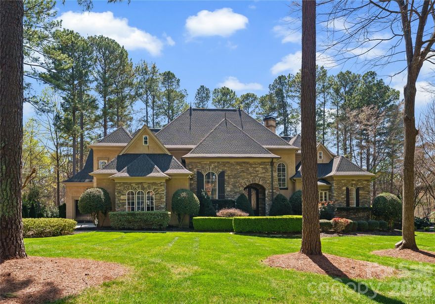 Enjoy breathtaking sunset views over the 3rd hole of Trump National Golf Course from this exceptional estate nestled within The Point. Set on 0.78 acres and offering over 5,700 square feet, this impeccably maintained 4 bedroom, 4.5 bath residence blends timeless elegance with modern comfort, delivering a truly elevated lifestyle.

The outdoor living experience is truly resort caliber, featuring an expansive hardscape designed for both relaxation and entertaining. Enjoy a thoughtfully designed custom hardscape sunken fire pit, outdoor kitchen with grill and bar, and a saltwater pool and spa, creating your own private oasis overlooking the course.

Inside, a grand two story foyer with designer lighting sets an impressive tone. The open concept main level is anchored by a stunning living room with a fireplace, custom built ins, and sweeping views, flowing seamlessly into a sunlit breakfast area and a beautifully appointed chef’s kitchen with granite countertops, designer finishes, and updated hardware.

A serene sunroom with its own fireplace offers a peaceful retreat, while the formal dining room, complete with butler’s pantry access, is ideal for hosting elegant gatherings. The main level primary suite is a true sanctuary, featuring a beautifully mantled fireplace, private access to a covered patio, an expansive custom walk in closet, and a spa inspired bath with a soaking tub and oversized walk in shower.

Upstairs, newly installed carpeting enhances a bright and spacious bonus room overlooking the backyard oasis and golf course. A secondary primary suite with en suite bath and walk in closet provides flexibility for guests or multi generational living. Additional generously sized bedrooms, a shared bath, and a versatile recreation space complete the upper level. Dual laundry rooms on both floors add everyday convenience.

Recent upgrades include a new roof in 2022, an EV charger garage hookup, updated lighting and fixtures, and extensive irrigation and hardscape enhancements.

Residents of The Point enjoy access to premier amenities through a Social Membership, including dining, fitness, tennis, swimming, and a vibrant calendar of community events, delivering a true country club lifestyle. A 12-month leased boat slip in The Point also now comes with the home!

This is luxury living redefined, where every detail has been thoughtfully curated for comfort, style, and effortless entertaining.