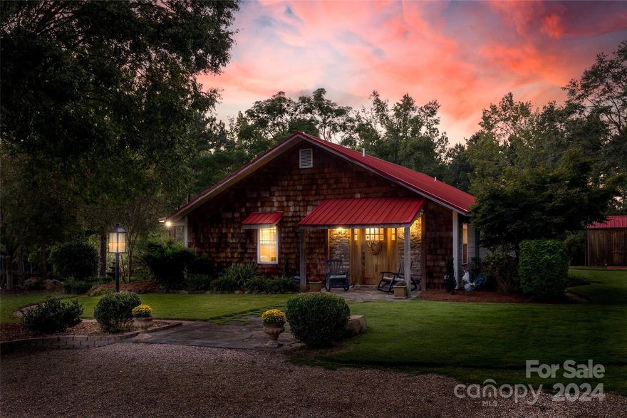 This enchanting farmhouse-style estate combines upscale executive living with countryside charm. Surrounded by water on one side and a tree farm on the other, this rare custom home offers unmatched privacy. Built in 2007 with Level-2 hurricane construction, rebar anchors, spray-foam insulation and premium windows, it’s designed for durability and energy efficiency. The cedar and hardiplank siding complement Tennessee River Rock, blue slate walkways and brick pavers. Spanning nearly 2,000 sq ft, the home features luxury concrete floors, a chef’s kitchen with custom cabinetry, Quartz countertops, gas cooktop and a 9-seater island. Enjoy water views from the covered porch or the outdoor kitchen and firepit. Accessibility features include a roll-in shower and wide door frames. Recent upgrades include a 30x36 barn/garage, new AC unit and metal roof. The property also has a natural spring and is five minutes from Lake Wateree. Don’t miss this rare opportunity for peaceful countryside living!