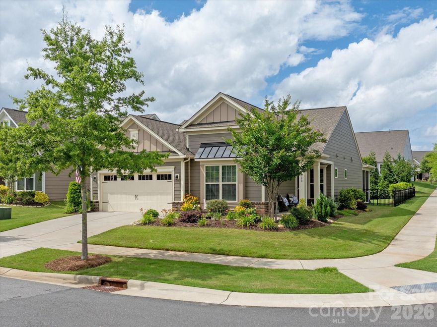 Nestled on a premium corner lot in the desirable 55+ community of TREE TOPS this beautifully maintained home welcomes you with a charming Southern wraparound porch and exceptional curb appeal. Surrounded by professionally landscaped gardens, mature trees, and vibrant seasonal blooms, the fenced backyard offers a private retreat highlighted by a spacious screened porch perfect for enjoying peaceful mornings, evening gatherings, and picturesque views of the lush green landscape. The home's desirable side-entry orientation and corner-lot setting, fills the interior with abundant windows and sunlight throughout.  The kitchen features light gray cabinetry, elegant white quartz countertops, an oversized island ideal for everyday living and entertaining, AND direct views of the beautiful, private backyard. Family room with fireplace, generously sized owner's suite with large walk-in closet and dual vanities, and private secondary bedroom ideal for guests. Rare and valuable upgrades include a whole-house WATER FILTRATION SYSTEM and a whole-house GENERATOR providing added comfort and peace of mind. Convenient CUSTOM drop zone off the garage with beautiful cabinetry and plenty of storage! Tree Tops is a serene GATED, active adult community that offers peaceful seclusion AND vibrant activity. Residents enjoy the state of the art fitness center, pool, tennis/pickleball courts, fishing pier, canoes, and bocce ball. Beyond fitness and recreation, the clubhouse, cabins, and amphitheater offer a variety of social spaces and endless activities. A beautiful home and lifestyle you will love!
