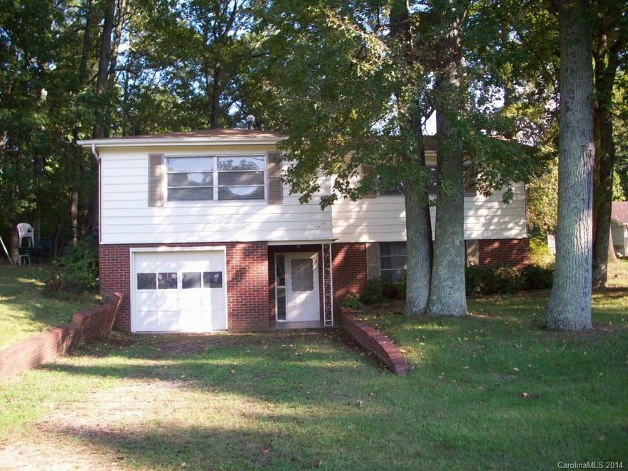 Vintage 50's home with adorable new kitchen.  Hardwoods on main level except bath and kitchen.  Three large bedrooms.  One large bath w/new oversized shower.  Lower level adds additional 200 sq. ft. to be used as flex
space.  Wonderful wooded lot.  1 car garage + 1 carport.
