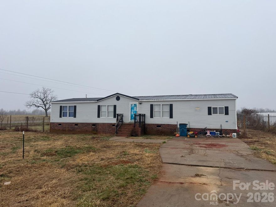 A Place to Call Home in Peaceful Cleveland, NC
Tucked away in a quiet setting with no HOA, this 3-bedroom, 2-bath double-wide home sits on a generous .58-acre lot, offering the space, freedom, and privacy so many buyers are looking for. Located just about 50 minutes from Charlotte, you can enjoy the calm of country living without giving up access to the city.
Inside, you’ll find a welcoming layout with a drop-down kitchen, a spacious den with a cozy fireplace—perfect for relaxing evenings—and a primary suite featuring a jacuzzi tub, ideal for unwinding after a long day. The home does need some updates, but that also means an opportunity to add your personal touch and truly make it your own.
Whether you’re a first-time buyer dreaming of homeownership or someone looking for a peaceful place to settle down, this home offers the chance to create something special.
Owner financing available with minimum of 10% down payment.

Motivated seller—bring your offers and start your next chapter here.