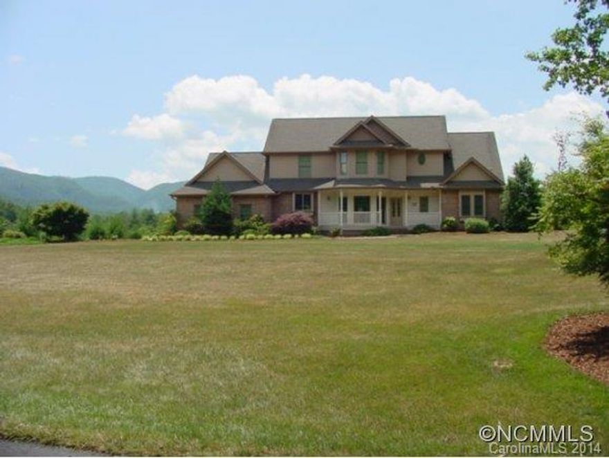 Incredible views of Bearwallow Mountain and the Cane Creek Valley from this beautiful home on a level corner lot. Open floorplan with covered deck integral to kitchen and breakfast room for outdoor living. Level drive leads to 2 car garage with main level access to the kitchen while lower drive offers easy access to spacious walkout basement and 1 car garage. Quiet, peaceful setting close to town. Lots of natural light and storage. Huge yard!