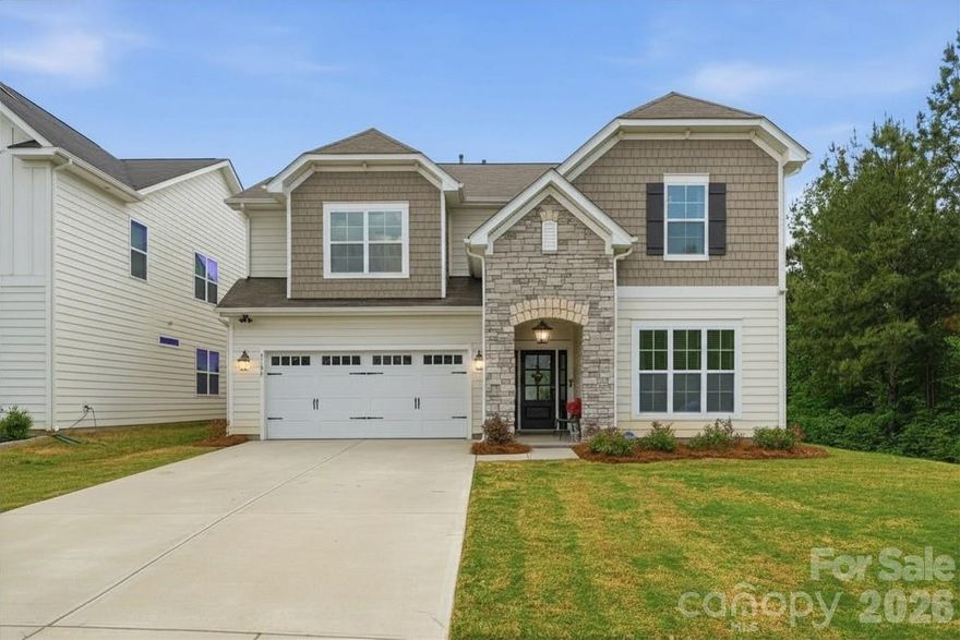 Stunning, meticulously designed floor plan in highly desirable Kennington! This 3,200+ sq. ft. residence seamlessly blends luxury and comfort in a quiet, walkable, sidewalk-lined community. Filled with natural light and facing North/East, the home showcases soaring ceilings and a thoughtfully curated collection of designer upgrades, including premium cabinetry, white oak luxury plank flooring, upscale carpet and tile, Carrera-style quartz countertops, and designer lighting, ceiling fans, and plumbing fixtures throughout.

Designed for seamless entertaining, guests are welcomed by a multi-car driveway, covered front porch, and a wide foyer that opens into an expansive open-concept layout. The Chef’s Kitchen is a true showstopper, featuring custom cabinetry, a large seated island with farm sink, premium stainless appliances—including a 5-burner gas range with exterior venting—and a spacious pantry. A convenient drop zone sits just off the 2-car attached garage. The dining area comfortably seats 10+ and flows effortlessly into a light-filled living room anchored by a stone gas fireplace and custom built-ins. A versatile flex room—perfect for a home office, library, hobby room, or yoga studio—along with a guest bedroom and ensuite, complete the main level.

Upstairs offers an impressive 240+ sq. ft. bonus room, a large laundry room with utility sink, and two generously sized secondary bedrooms. The primary suite is a private retreat with a 150+ sq. ft. walk-in closet and a spa-inspired ensuite with dual vanities.

Enjoy exceptional outdoor privacy from the serene screened-in porch overlooking a fully fenced backyard, with protected woods to the right and protected greenspace at the rear. Unbeatable location just minutes from Reedy Creek Park & Nature Preserve, greenways, UNCC, shopping, and dining, with effortless access to Uptown, NoDa, Plaza Midwood, Cabarrus County, and Mint Hill. This is the one you’ve been waiting for!