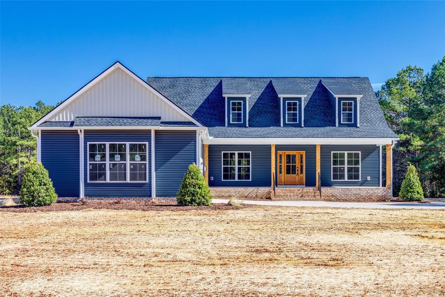 Welcome to this stunning NEW 4-bedroom, 3-bathroom home, perfectly nestled on over 2 acres of serene land. The open-concept kitchen & living area create a seamless flow, combining functionality & comfort, making it ideal for entertaining. A separate formal dining room offers an elegant space for meals & gatherings.  An oversized pantry provides ample storage. The main level primary suite is a true retreat, with a beautifully tiled spa-like master bath. The downstairs features durable LVP flooring throughout, while the upstairs bedrooms & bonus room are carpeted for added comfort.  The generous bonus room offers flexible space with endless potential. The walk-in attic provides HUGE additional storage. Outside, you'll enjoy a welcoming front porch and a screened back porch to host a barbecue, relax with a book, or simply enjoying the view of tranquility. This new home offers the perfect balance of peaceful country living & convenient access to nearby Rock Hill, Chester, or Lancaster.