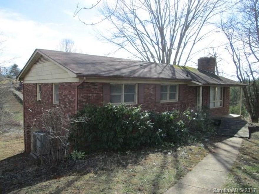 Mid century brick ranch style home on .84 acre lot. Main level- 2 bedrooms, each with their own half bath and a full bathroom in the hall. Living room with a wood stove and a large eat in kitchen with access to rear deck from the dining area. Basement- has a workshop/single garage, large family room with a fireplace, utility room and full bathroom. Nice level front yard and sloping rear yard. Winter mountain view. Private well. Homepath Ready Buyer Program and Home Ready Mortgage may apply.