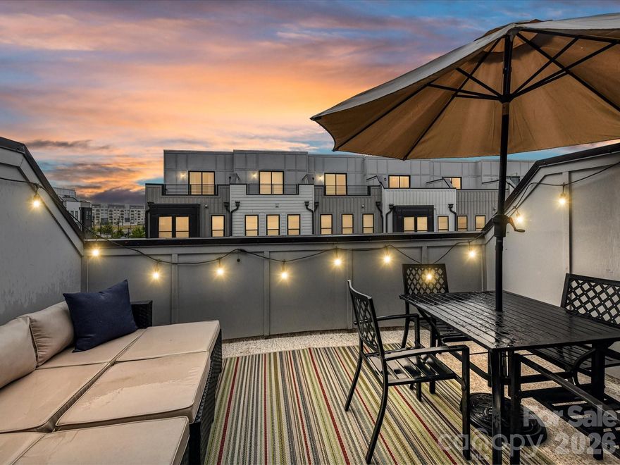 Location! Location! Location! Set within vibrant SouthEnd, Tremont Station’s refined community boasts sidewalks, classic lamp posts, landscaped green spaces, and a dedicated dog park. Enjoy exceptional walkability to neighborhood grocery spots, celebrated dining, breweries, boutiques and other retailers - all part of one of Charlotte’s most dynamic urban neighborhoods that provides luxury and convenience.
Commercially-built by Toll Brothers, this 4-story luxury townhome blends superb construction with elevated design and functionality. From the private oversized lower-level tandem garage with extra storage to the expansive rooftop terrace, every level is thoughtfully designed for a stylish, low-maintenance lifestyle. Sunlight fills the home through oversized windows with custom blinds, creating a bright, energizing space for both relaxing and working from home. The main level is made for gathering—an open kitchen with stainless steel appliances including Whirlpool gas range and microwave, LG refrigerator, and a large island sits perfectly between the dining and living areas, making entertaining effortless whether it’s a casual dinner with friends or a formal weekend get-together. All televisions in townhome convey! Upstairs, the primary suite offers a spa-inspired bath and walk-in closet, a laundry closet complete with white Whirlpool stackable washer/dryer, and a spacious second bedroom en-suite. The top floor adds even more flexibility with a 3rd bedroom, full bathroom and a spacious loft ideal for a home office or lounge, and a rooftop terrace—perfect for sunset drinks or simply unwinding.