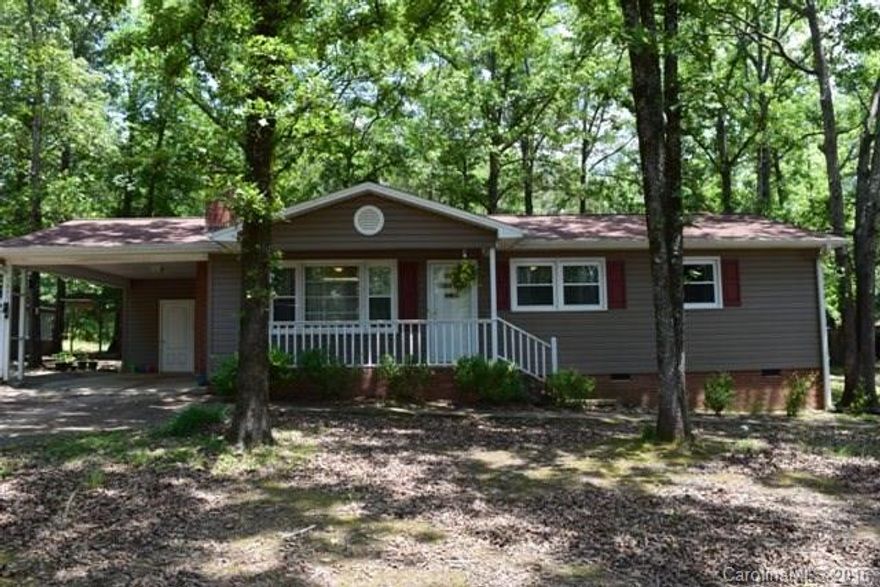 Such a cute home on a large one acre lot! This is a split bedroom plan with 3 bedrooms, 2 baths, great room with wood burning fireplace.  Open layout, large kitchen, cozy dining and living room space.  Extra large covered patio area with a wooded view.